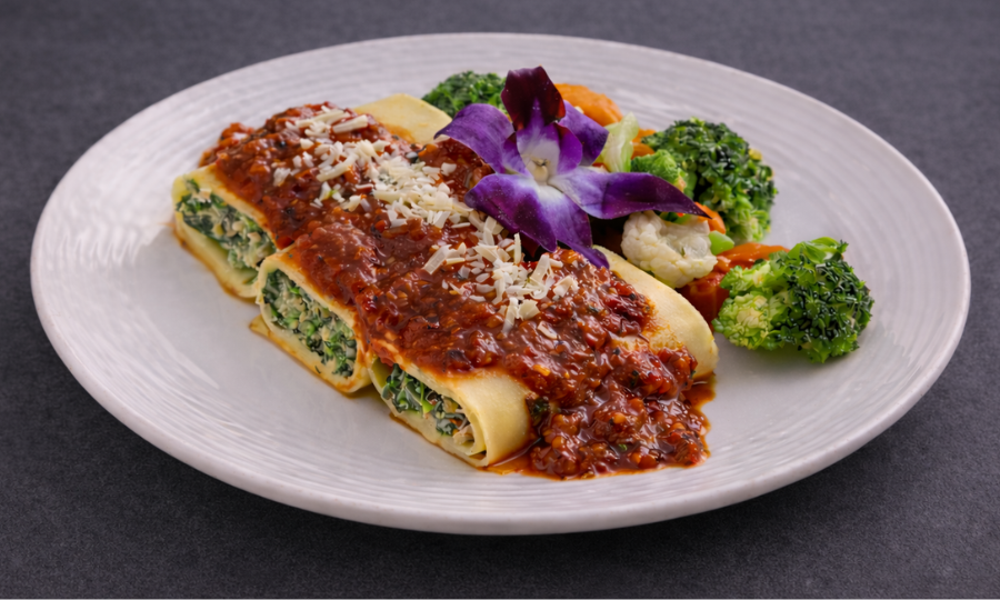 Eggplant and ricotta cannelloni with marinara sauce plated for vegetarian catering