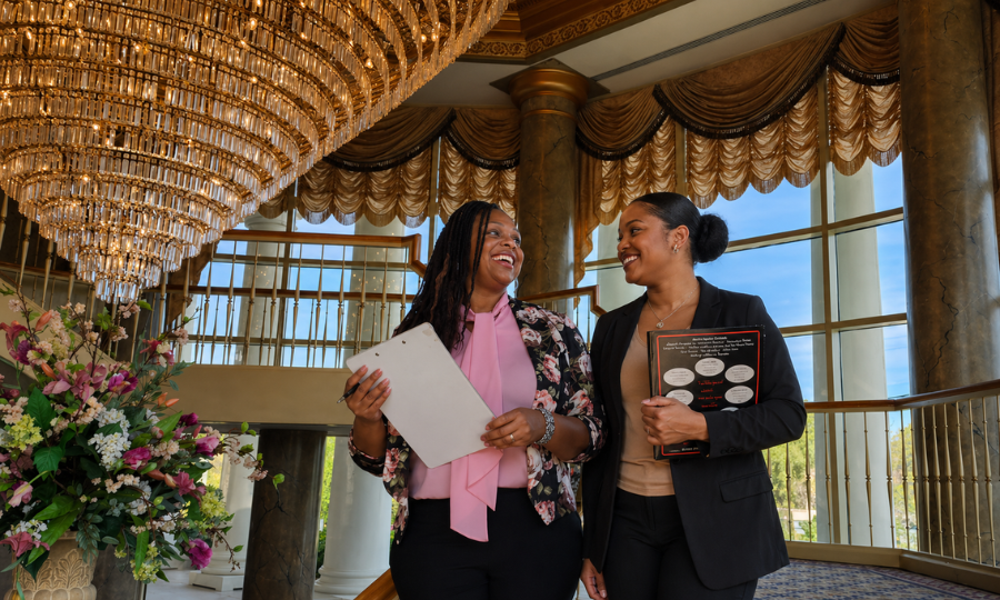 Martin’s event planner meeting with a bride in the grand lobby of Martin’s West, offering wedding planning guidance.