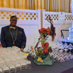 Elegant Martini Bar with ice sculpture and smiling bartender at Martin's Caterers event.