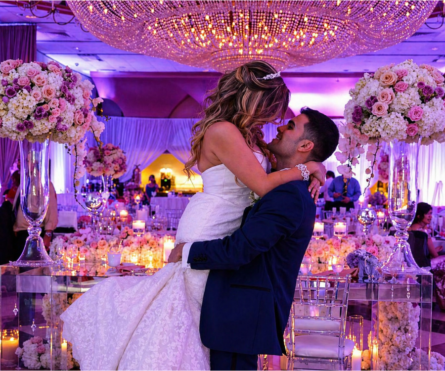 Bride and groom beneath chandelier at Martin’s Crosswinds ballroom